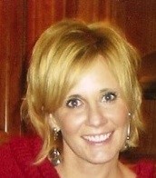 Headshot of Dr. April Brannon, smiling, wearing a red sweater